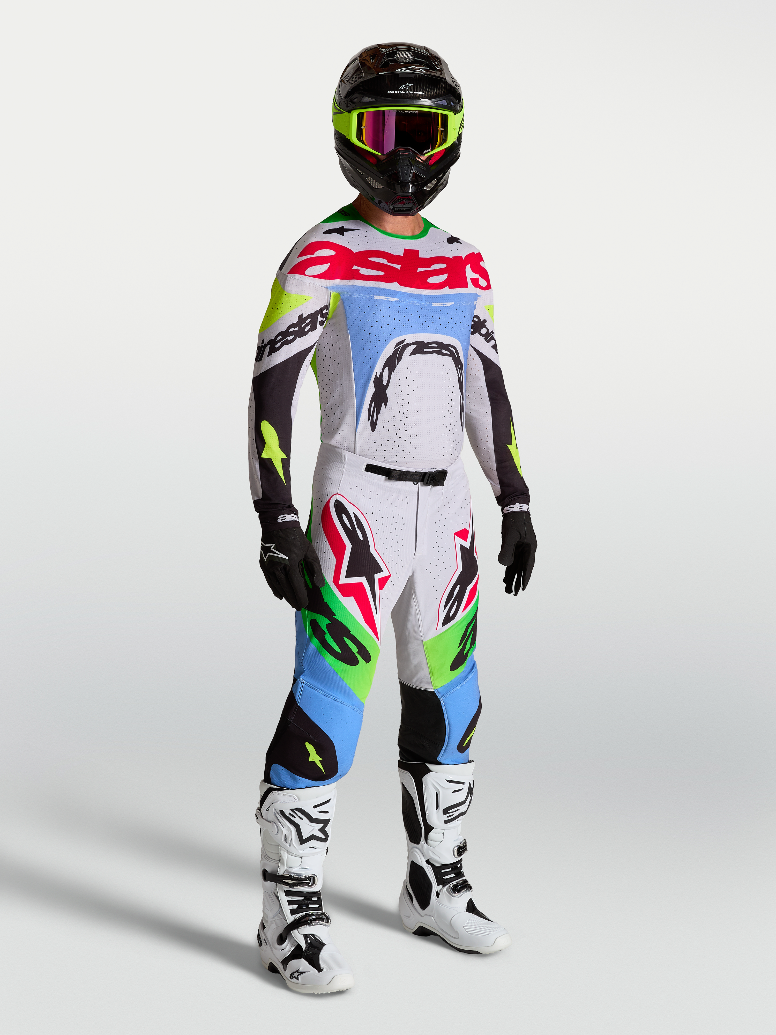Alpinestars Supertech Dyna broek, heren motocrossbroek in lichtlila en fluogroen, deel van een volledige race-uitrusting.