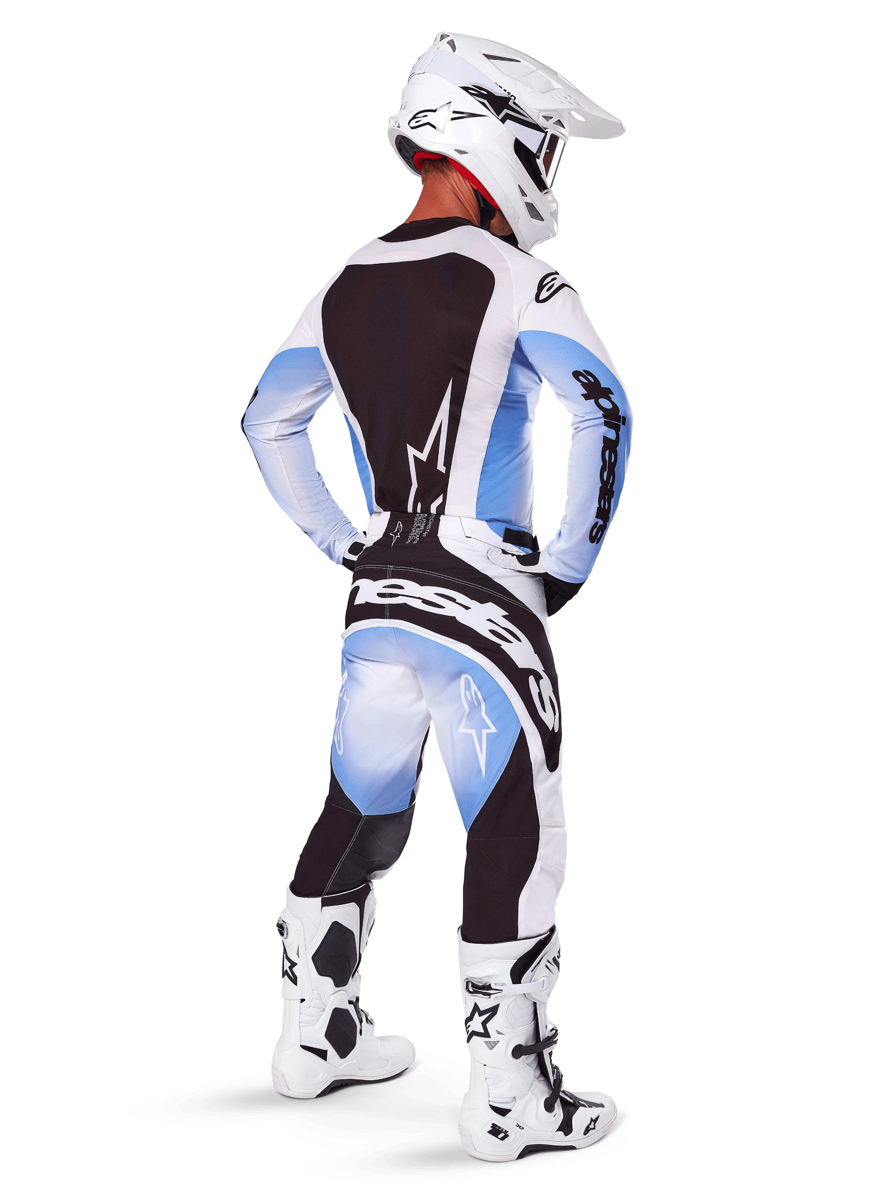 Alpinestars 2025 Techstar Melt motorcross tenue, van achteren gezien, crossbroek en jersey met zwart, blauw en wit kleurverloop, witte helm en wit-zwarte laarzen, volledige off-road race-uitrusting.