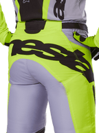 Alpinestars 2025 Racer Veil Pants, Motocross Pants, Gray and Yellow Fluo, rear view featuring large black branding across the seat, worn with matching jersey and gloves, technical off-road design