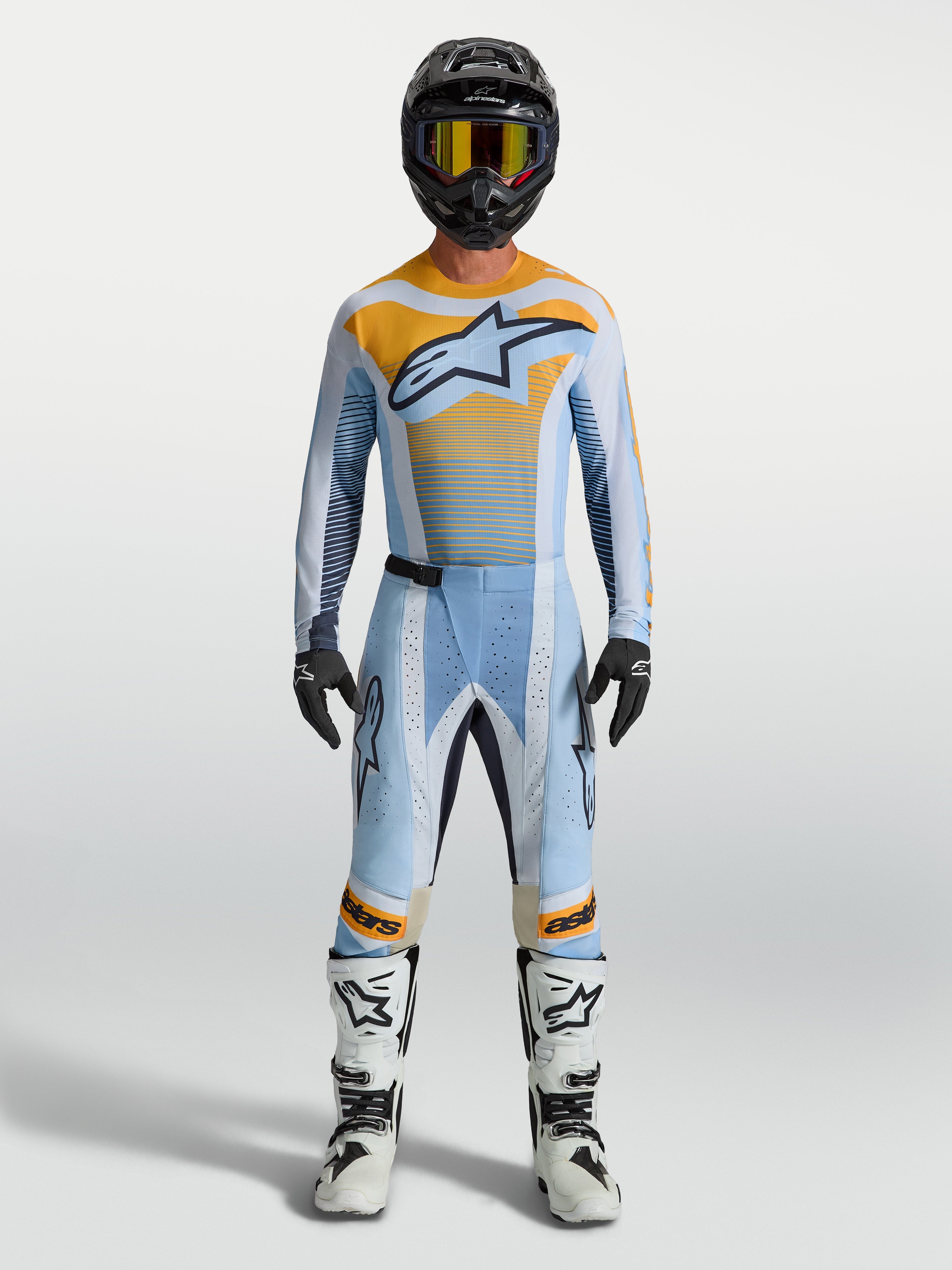Alpinestars Techstar Maven broek in blauw en oranje, motorcrosskleding voor heren met racepasvorm en stretchzones.