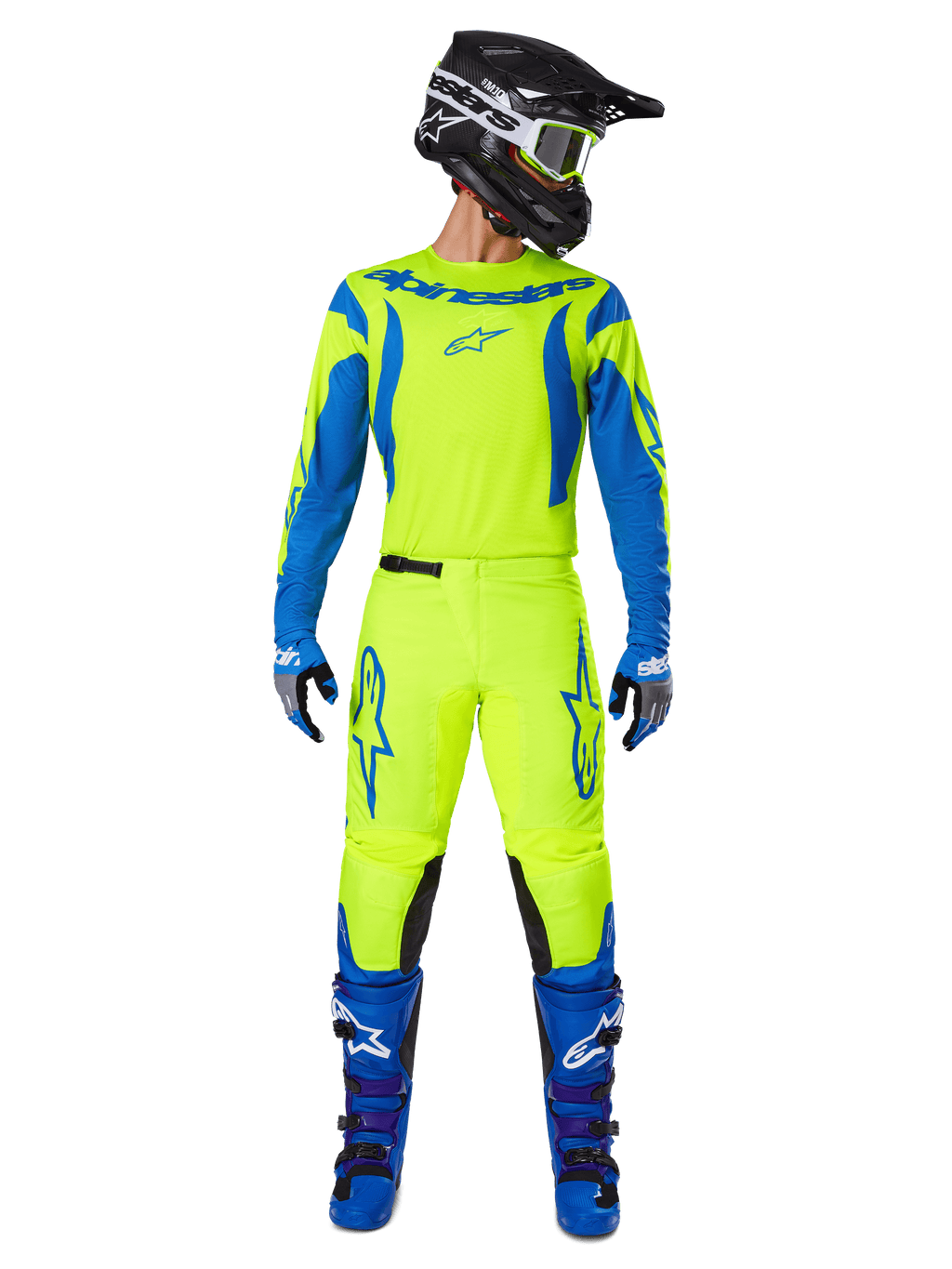 Alpinestars 2025 Fluid Haul crossbroek, motorcross broek, fluorescerend geel en blauw, gedragen als compleet racepak met bijpassende jersey, blauwe laarzen en zwarte helm, met opvallende blauwe logo's op de dijen en zwarte kniepanelen