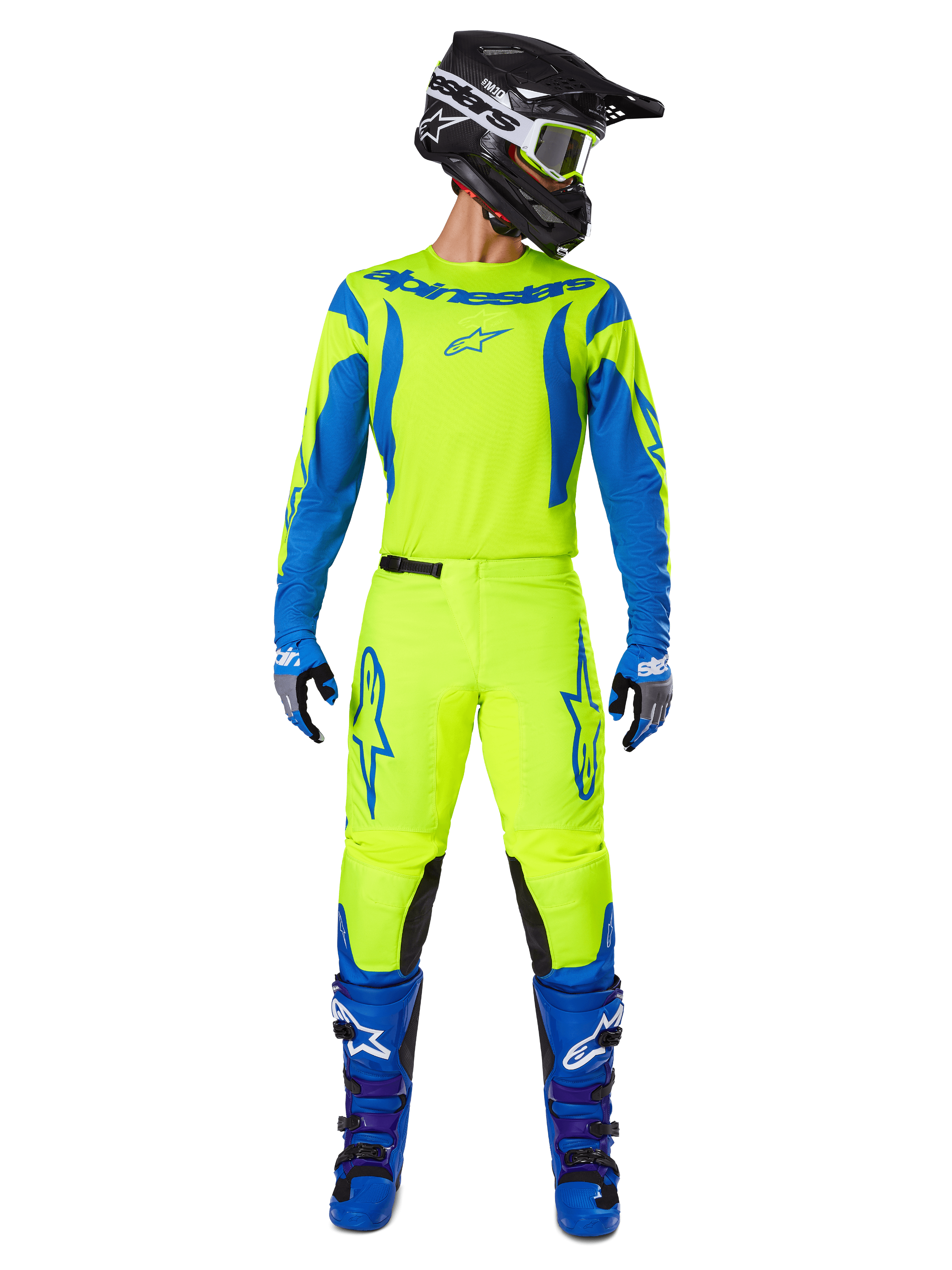 Alpinestars 2025 Fluid Haul crossbroek, motorcross broek, fluorescerend geel en blauw, gedragen als compleet racepak met bijpassende jersey, blauwe laarzen en zwarte helm, met opvallende blauwe logo's op de dijen en zwarte kniepanelen