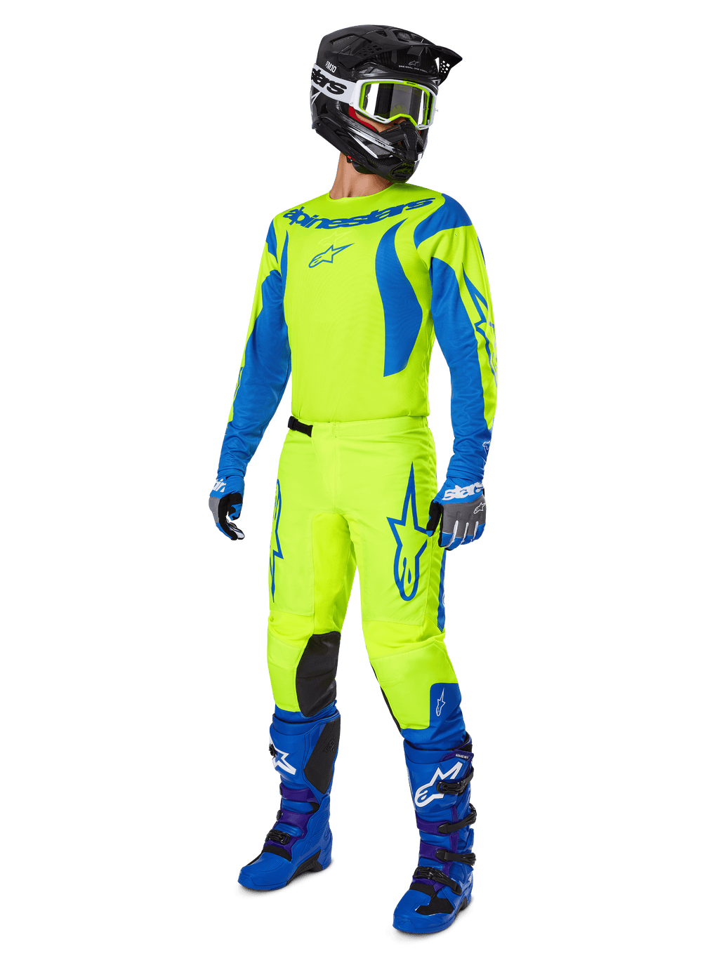 Alpinestars 2025 Fluid Haul crossbroek, motorcross broek, felgeel fluo en blauw, gedragen als onderdeel van een complete race-uitrusting met bijpassend shirt, blauwe laarzen en een zwarte helm, high-visibility ontwerp voor off-road rijden.