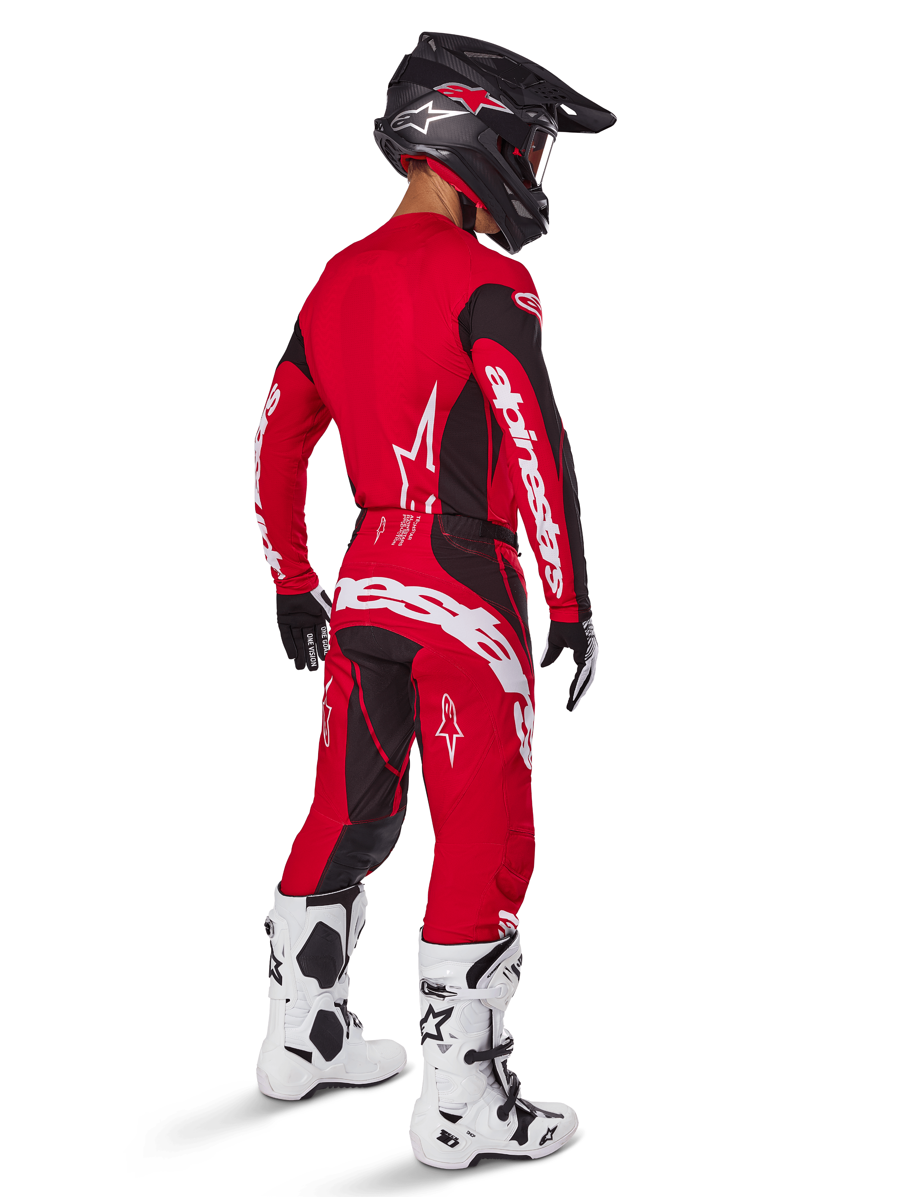 Alpinestars 2025 Techstar Dreem crossbroek, motorcross broek, felrood en zwart, gedragen door een rijder van achteren gezien in een volledige race-uitrusting met bijpassende rode jersey, zwarte helm en witte laarzen, opvallende witte Alpinestars-branding en zwarte stretchpanelen