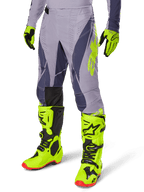 Alpinestars 2025 Techstar Dreem Gear Set, motorcrossbroek en jersey, grijs met donkerpaarse en neongele accenten, gedragen met bijpassende neongele laarzen en handschoenen, professionele racepasvorm voor off-road motorcross