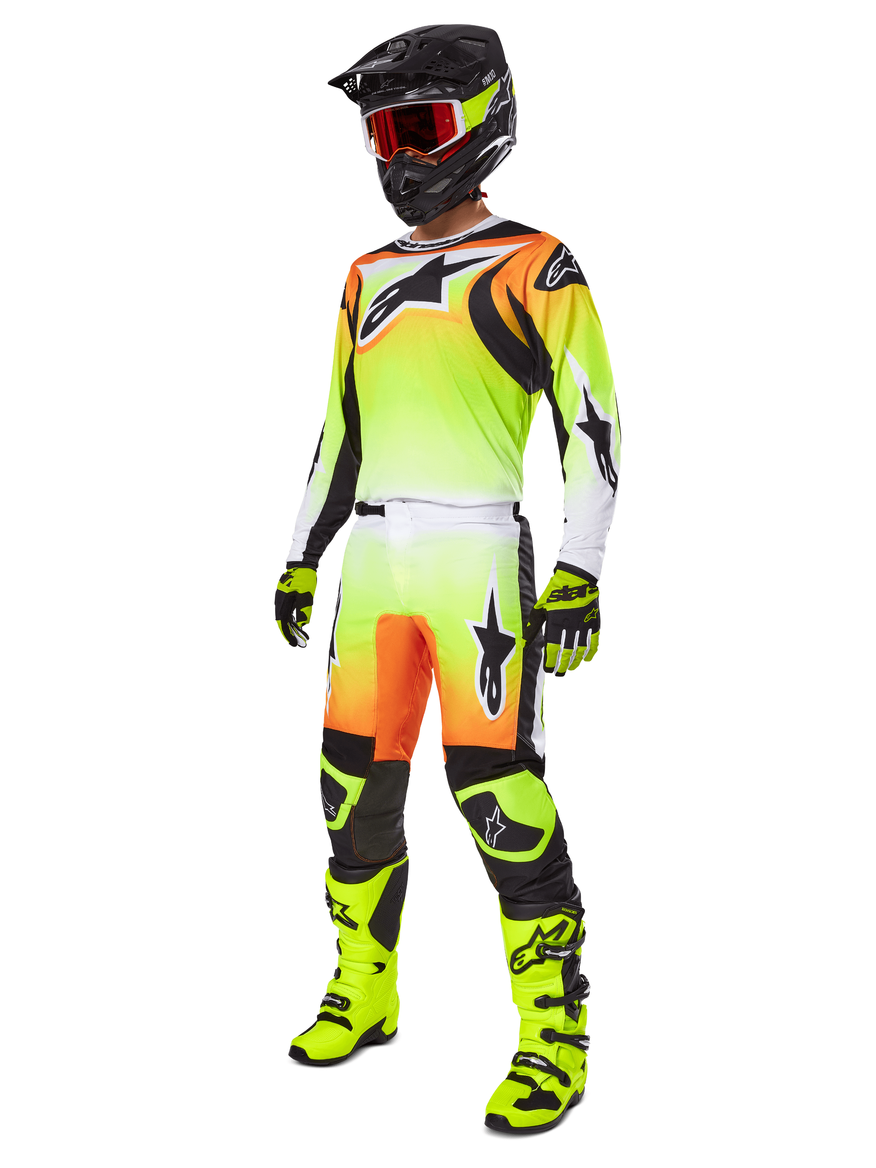 Alpinestars 2025 Fluid Wurx broek, motorcross broek in geel en zwart met een levendig geel-naar-wit kleurverloop en oranje accenten, gedragen door een motorcrosser als onderdeel van een complete outfit met bijpassende jersey, zwarte helm en neongele laarzen.