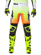 Alpinestars 2025 Fluid Wurx crossbroek, motorcrossbroek, neongeel en oranje, zwarte en witte sterlogo's, strak race-ontwerp met zwarte kniestukken, gecombineerd met bijpassende neongele laarzen en handschoenen