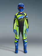 Motocross rider wearing complete racing gear, Alpinestars 2026 Techstar Nomur Pants and jersey in Yellow Fluo and Dark Navy, featuring blue accents and logos, paired with a blue helmet, gloves, and boots for a coordinated off-road racing look.