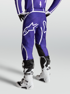 Alpinestars Fluid Apex V2 broek voor heren, motorcrossbroek in blauw en wit, met ergonomische 3D-pasvorm en groot sterlogo op het rugpand.