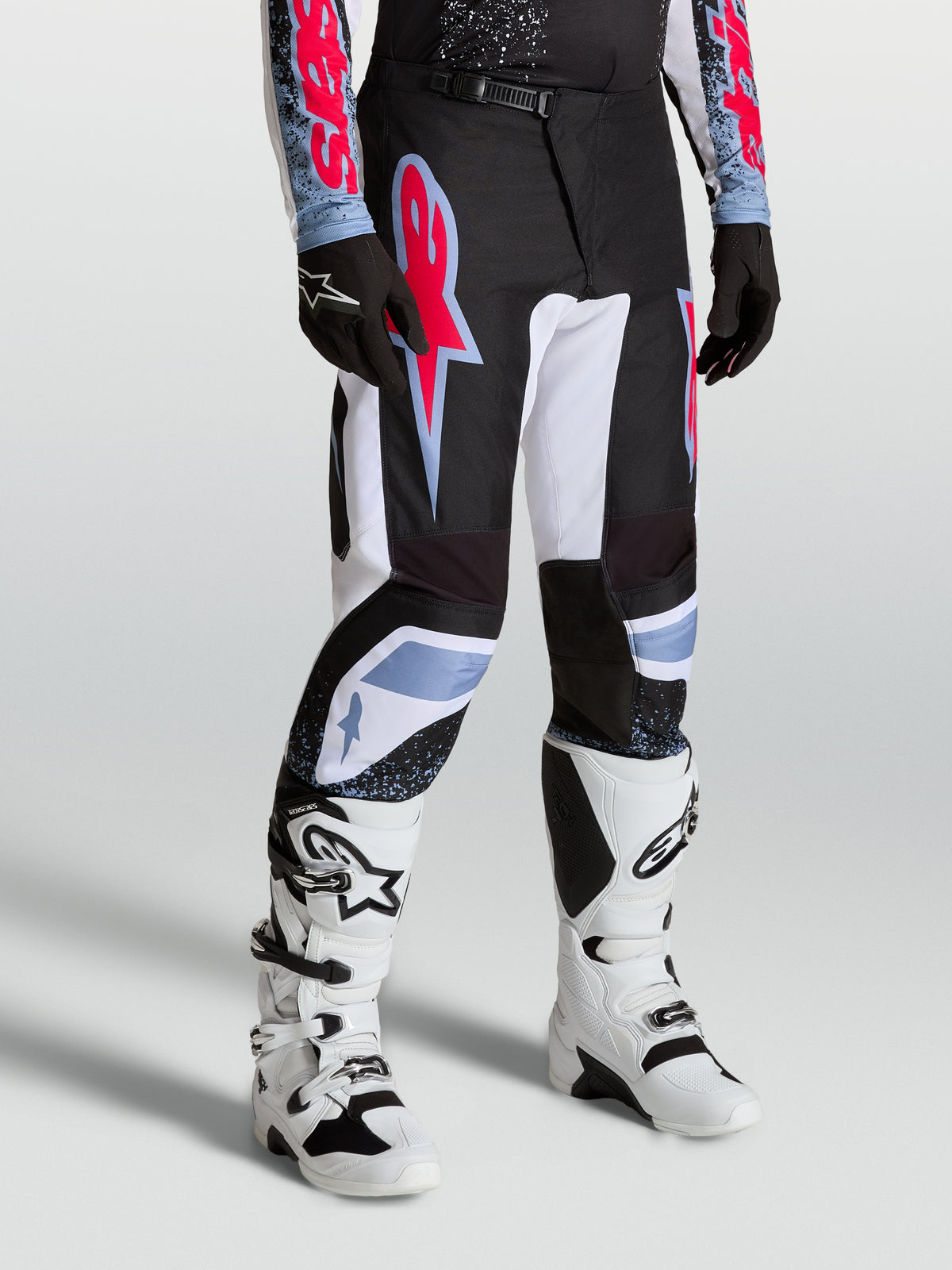 Alpinestars Fluid Drag Pants, men's motocross racing pants in black and white with red fluo and light blue accents.