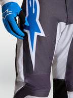 Alpinestars Fluid Drag broek, heren motocrossbroek in grijs en blauw met duurzame polystof en ster-graphics.