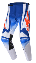Alpinestars 2023 Racer Semi Pants, motorcrossbroek, blauw, wit en fel oranje, voorzien van grote oranje sterlogo's, zwarte hittebestendige binnenpanelen bij de knieën en een voorgevormd ergonomisch ontwerp voor off-road prestaties.