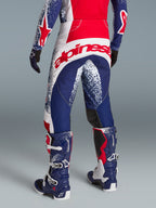 Alpinestars Techstar Unity motorcrossbroek, limited edition in rood, wit en blauw met groot logo op de achterzijde.
