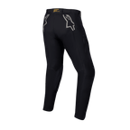 Alpinestars Techdura broek, zwarte enduro- en off-roadbroek, achteraanzicht met grijze sterlogo's op de heupen en gele branding op de achterkant van de tailleband, robuust stretch polyamide materiaal, duurzaam ontwerp voor motorrijden