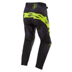 Alpinestars 2024 Techstar Rantera-broek, motorcrossbroek, zwart, navy en fluogeel, achteraanzicht met opvallende fluogele branding op het zitvlak, navy panelen met patroon en technisch zwart materiaal voor off-road raceprestaties