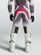 Alpinestars Jeugd Supertech Swan motorcrossbroek in grijs en fluorood, achteraanzicht met versterkt zitvlak.