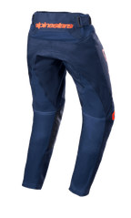 Alpinestars Youth 2023 Racer Narin Pants, jeugd motorcrossbroek, Night Navy en Hot Orange, achteraanzicht met oranje Alpinestars-branding op de taille en zwarte lederen binnenbeenverstevigingen, duurzaam textielontwerp voor off-road rijden
