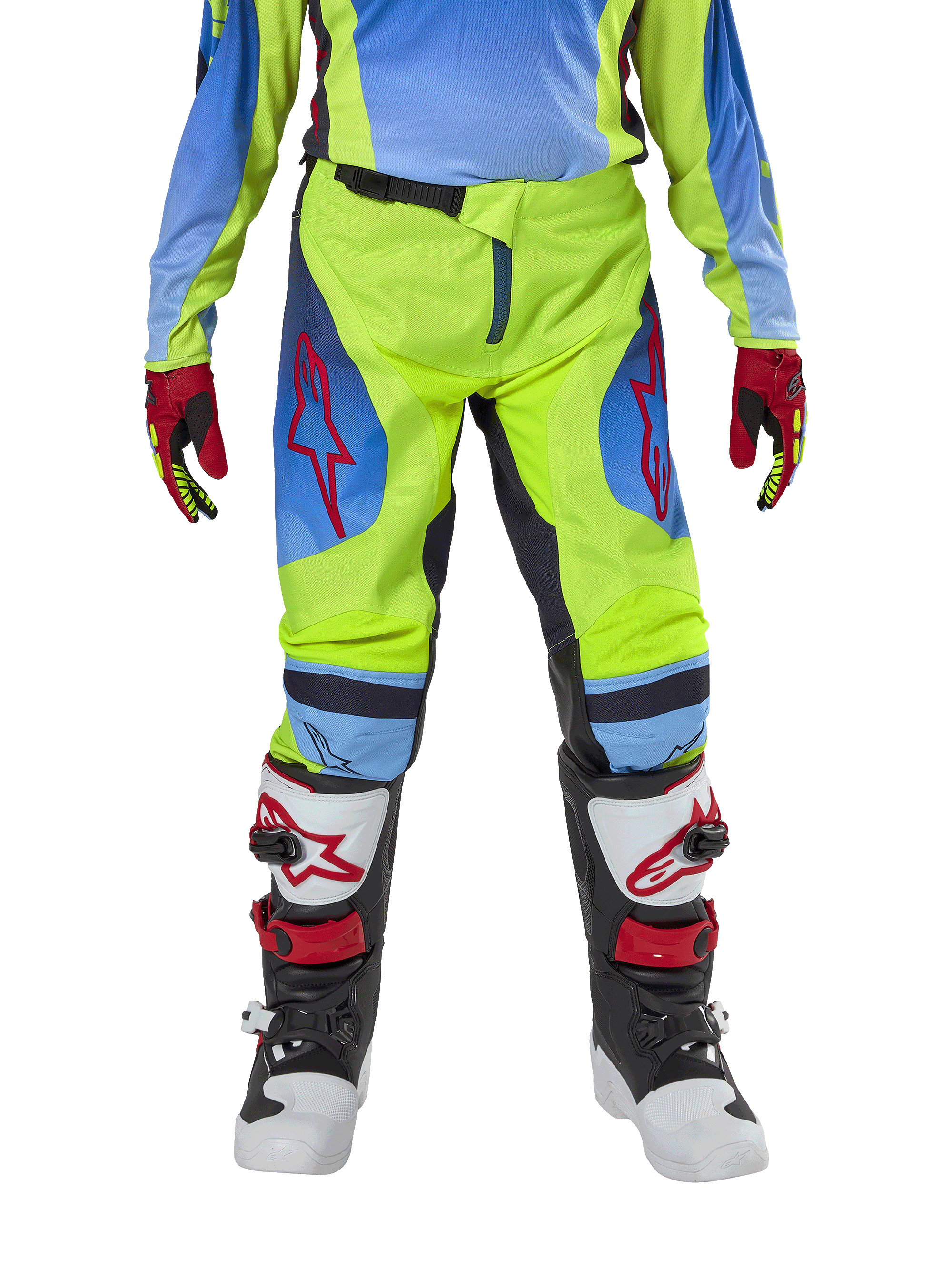 Alpinestars Youth 2024 Racer Hoen broek, motorcross broek, neongeel en donkerblauw, met rode sterlogo's op de dijen, gedragen met bijpassende jersey, rood-zwarte handschoenen en witte, zwarte en rode motorcrosslaarzen, duurzame uitrusting voor off-road rijden