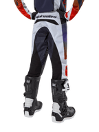 Alpinestars Youth 2024 Racer Hoen Pants, Motocross Pants, Light Gray with Hot Orange and Black accents, rear view featuring black panels on the seat and legs, bold branding on the back waist, worn with black and white motocross boots for off-road racing