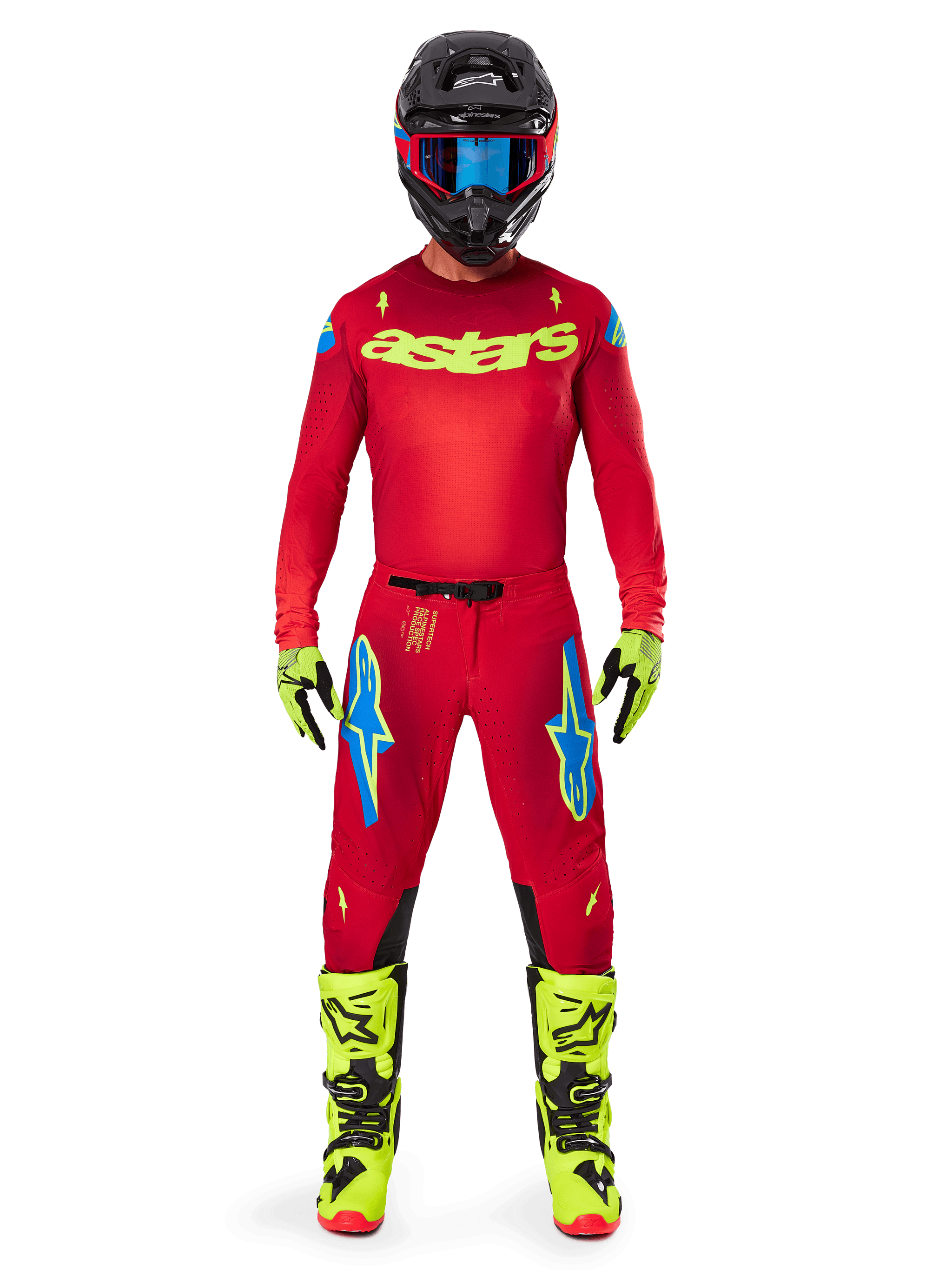 Motocross rider wearing the Alpinestars 2025 Supertech Maker Jersey and matching pants in Bright Red and Yellow Fluo, featuring yellow 'astars' branding on the chest, black helmet with blue goggles, yellow-fluo gloves and boots, complete professional racing outfit for off-road performance.