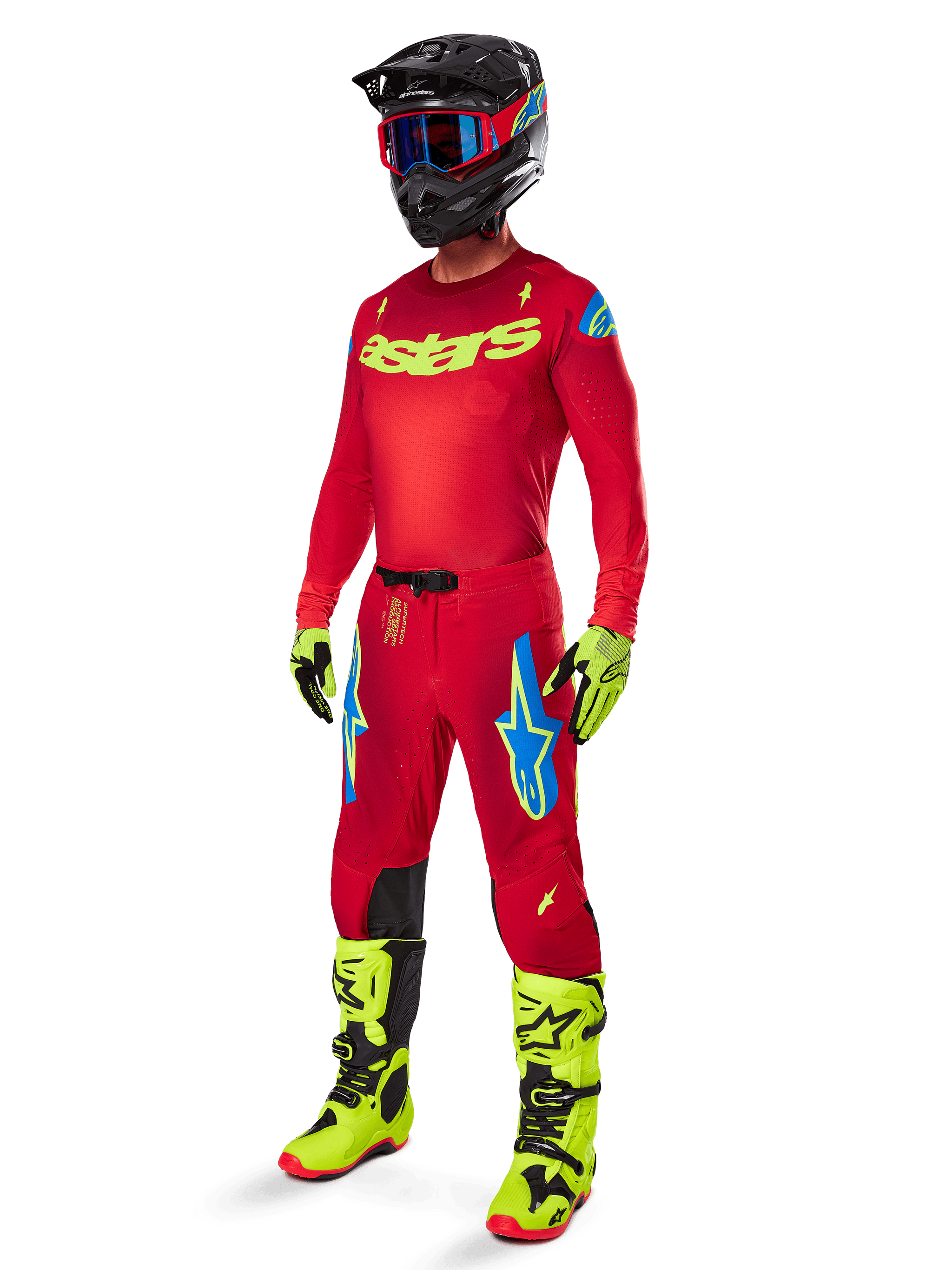 Motocross rider wearing the 2025 Supertech Maker Jersey, Bright Red with Yellow Fluo logos, matching red pants with blue and yellow accents, black helmet with blue and red detailing, yellow fluo and black boots, coordinated professional racing gear for off-road performance