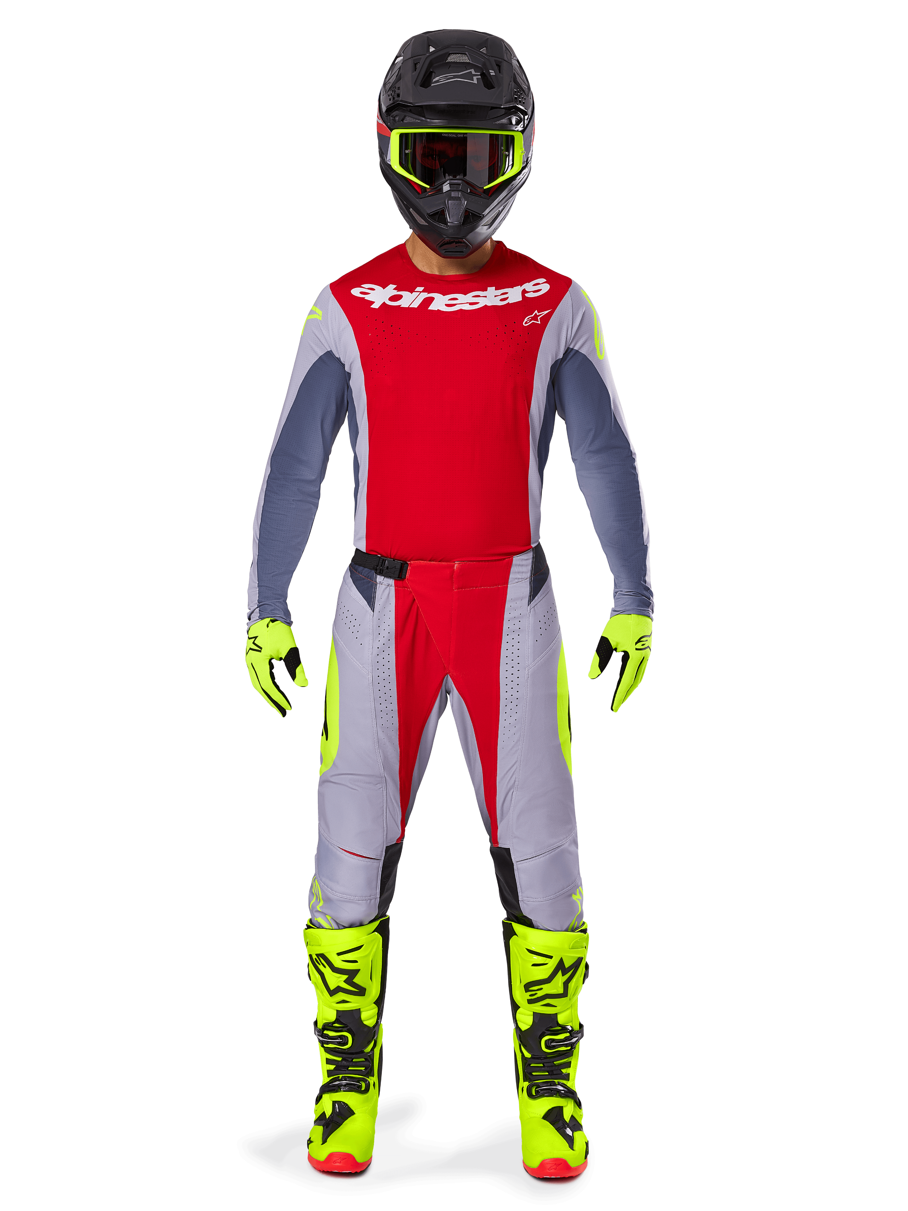 Motorcrosser in de Alpinestars 2025 Techstar Melt Gear Set, rood jersey met grijze mouwen en wit logo, bijpassende grijze en rode broek, fluogele crossbril, handschoenen en laarzen, complete motorcross-outfit voor off-road prestaties.