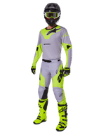 Alpinestars 2025 Racer Veil Gear Set, complete motorcross-outfit, grijs en neongeel fluo, bestaande uit jersey, broek, helm, bril, handschoenen en laarzen met zwarte accenten, professionele race-uitrusting voor off-road prestaties.