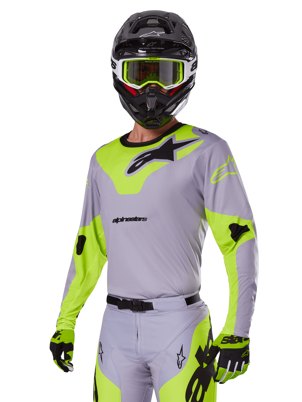 Motorcrosser met Alpinestars 2025 Racer Veil Gear Set in grijs en fluogroen, lichtgrijze jersey en broek met opvallende neongele panelen en zwarte Alpinestars-logo's, bijpassende handschoenen en een zwarte helm met neongroene bril, professionele off-road racekleding