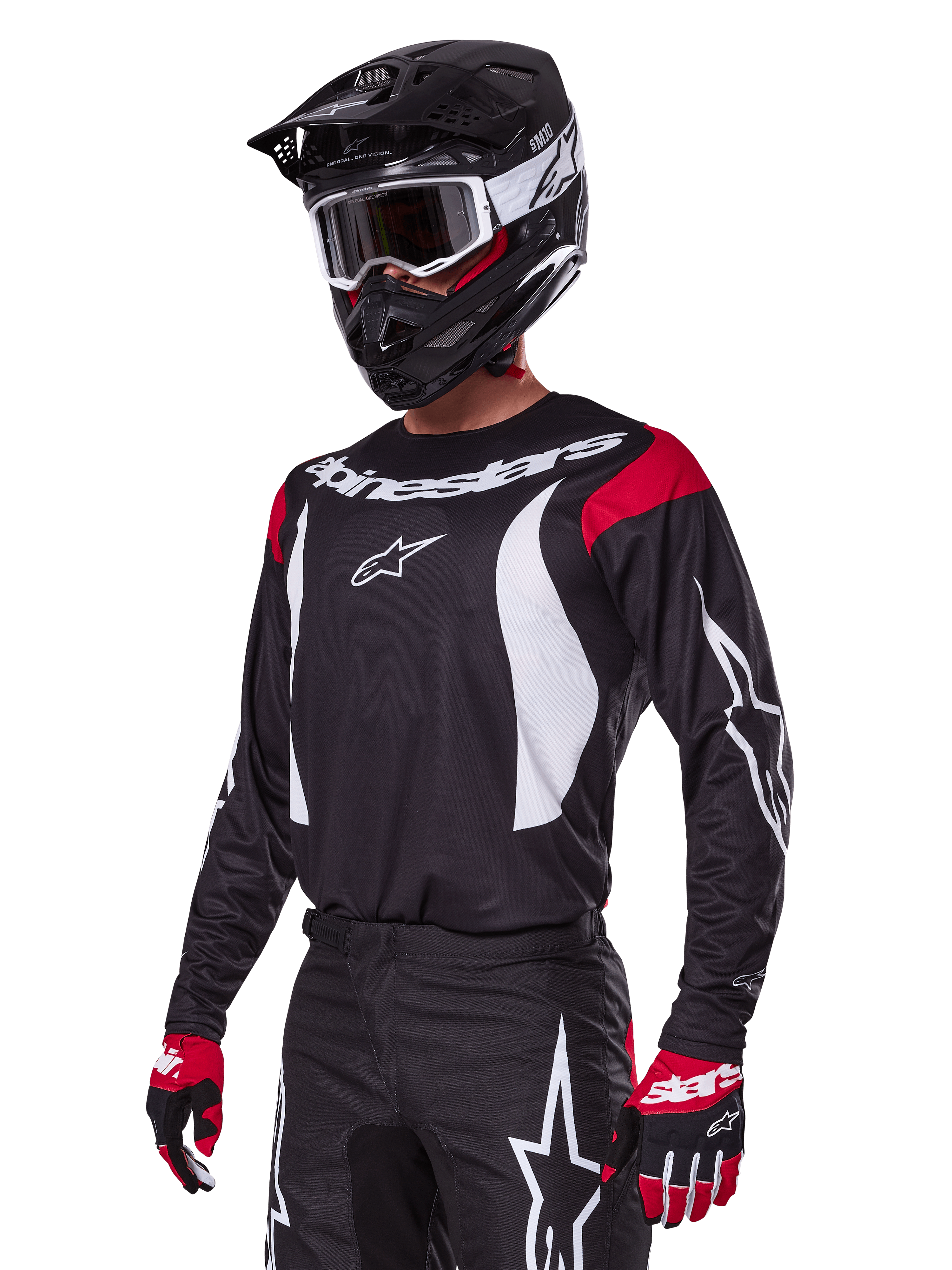 Alpinestars 2025 Fluid Haul Gear Set, motorcross outfit, zwarte jersey met rode schouderpanelen en witte graphics, bijpassende zwarte broek met witte ster-logo's, rode en zwarte handschoenen, zwarte helm met witte accenten en bril, gecoördineerde motorcrossuitrusting