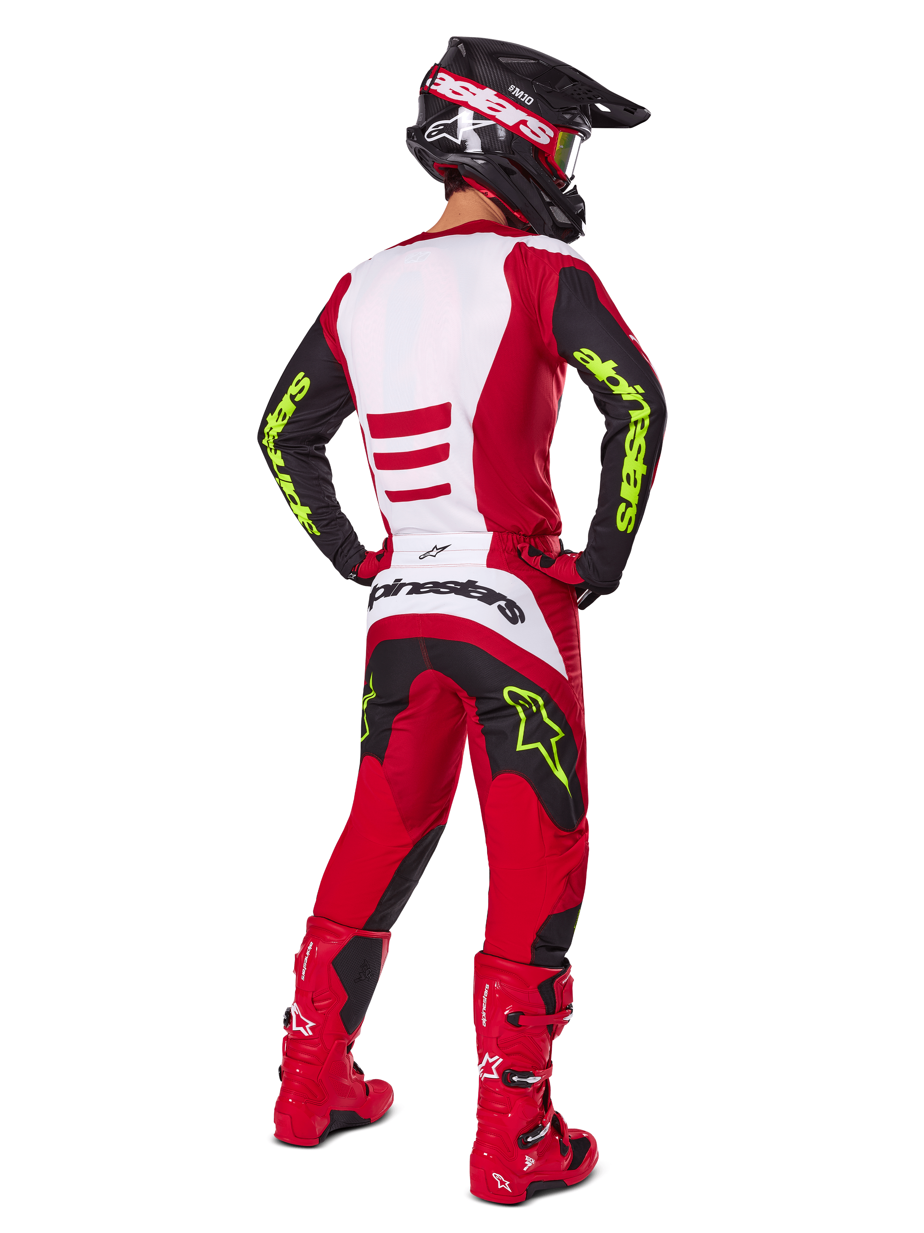Alpinestars 2025 Fluid Haul Gear Set, motorcrosser van achteren gezien, helderrood en zwart met witte panelen, neongele branding op mouwen en broek, bijpassende rode laarzen en zwarte helm, complete professionele off-road race-uitrusting