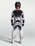 Alpinestars Techstar Swan Jersey and Gear Set, Men's Motocross Outfit in White and Black featuring rear splatter graphics.