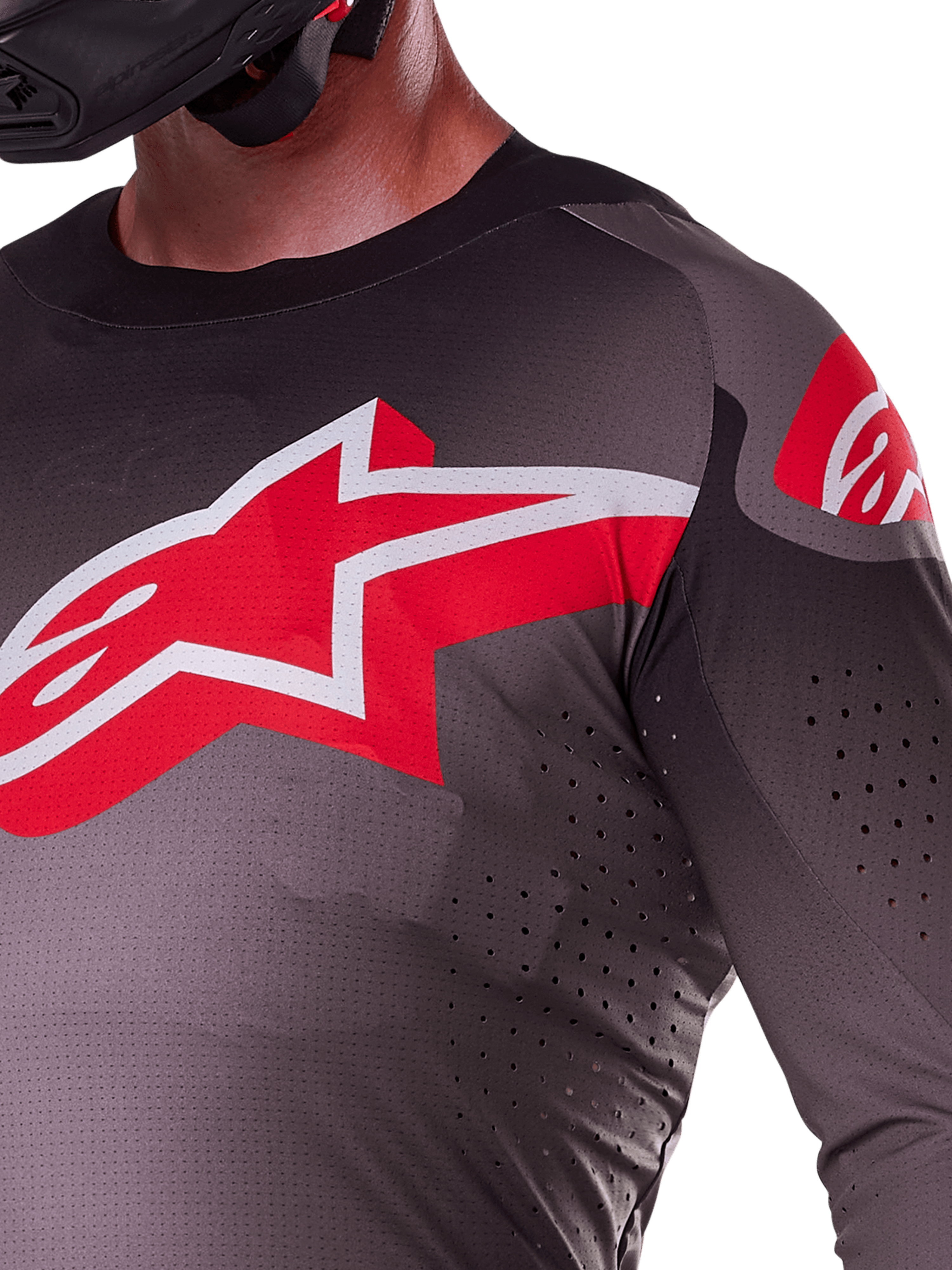 Alpinestars 2025 Supertech Lipan Jersey, Smoke Bright Red, close-up view showing the large red and white star logo on the chest, laser-cut perforations for airflow, and lightweight breathable fabric on a rider.