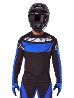 Alpinestars Techstar Dreem kledingset en jersey, zwart en blauwe motorcrossoutfit voor off-road racing.