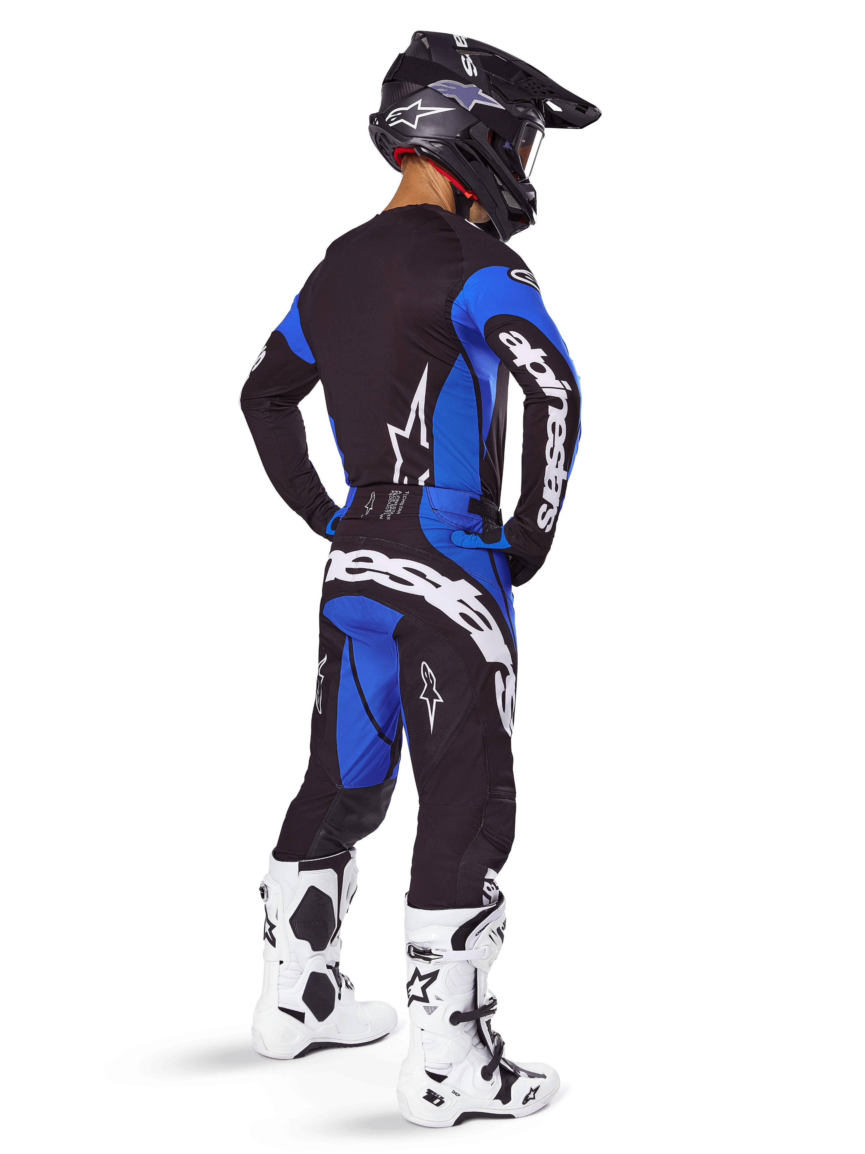 Alpinestars Techstar Dreem kledingset, zwart-blauwe motocrossuitrusting voor heren, achteraanzicht met witte motorlaarzen.