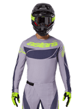 2025 Techstar Dreem Jersey en Gear Set, motorcross racetenue, lichtgrijs en donkergrijs met neongele accenten, voorzien van 'astars' branding, gedragen met zwarte helm, bril en bijpassende handschoenen, technisch geperforeerd materiaal voor off-road prestaties