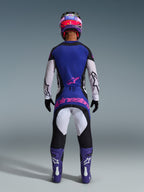 Motocross rider viewed from the back wearing the 2026 Techstar Knif Jersey, Black Light Gray Purple, matching motocross pants with pink branding, purple boots and helmet, coordinated high-performance off-road gear