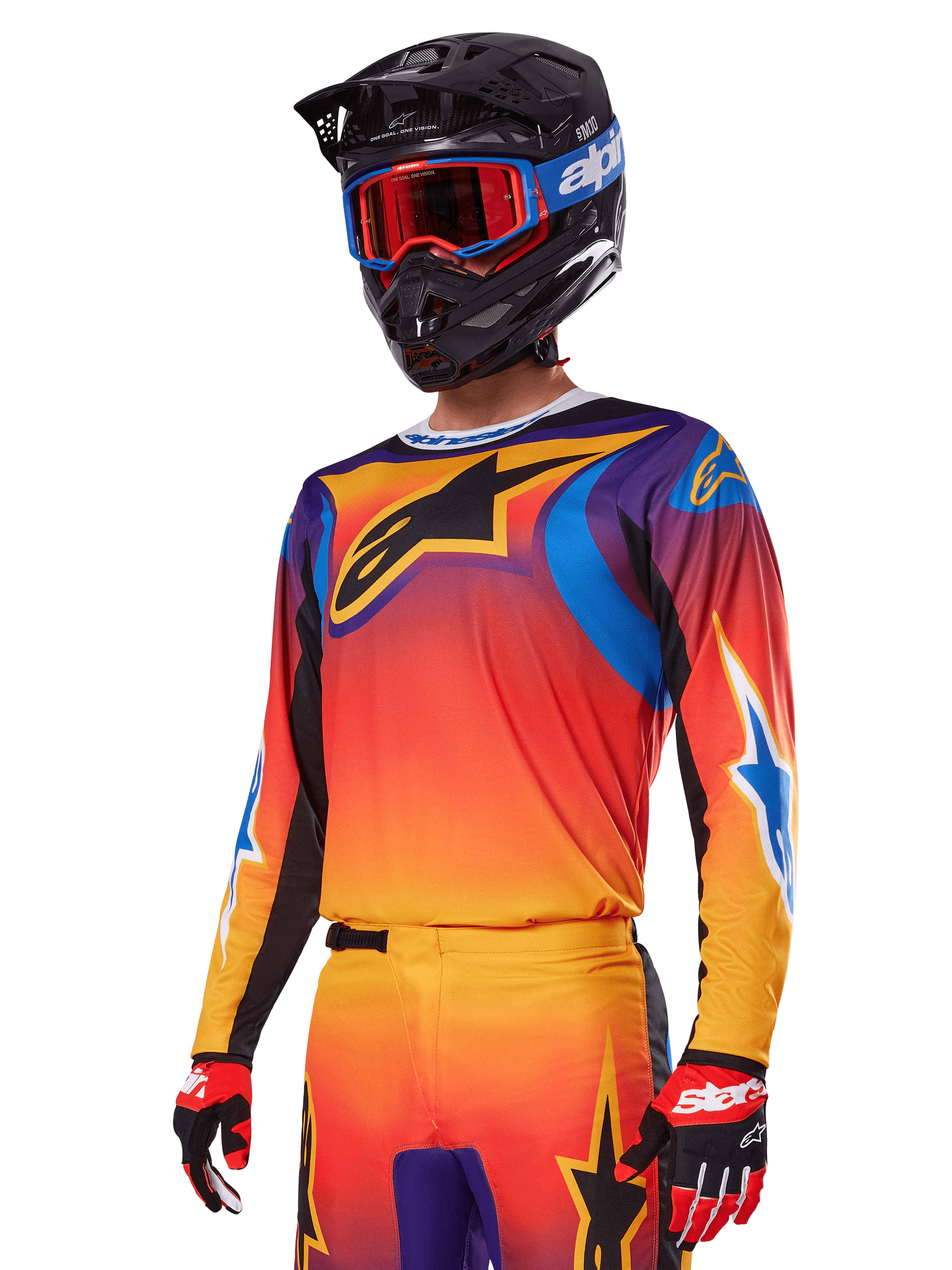 Alpinestars 2025 Fluid Wurx gearset, motorcross set, oranje, paars en blauw kleurverloop, voorzien van een groot zwart A-stars logo, gedragen met een zwarte helm en blauwe bril, gecoördineerde outfit voor professioneel off-road racen