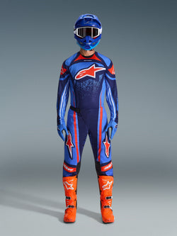Alpinestars 2026 Techstar Nomur Gear Set, Motocross Racing Gear, Dark Navy, Orange and UCLA Blue, complete riding outfit with blue helmet, matching jersey and pants, blue gloves, and bright orange boots, featuring star logos, performance off-road protection