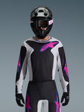 Alpinestars 2026 Fluid Grid Jersey, Motocross Jersey, Black Light Gray and Purple, worn by a rider with matching off-road pants, black helmet, and goggles, complete performance racing gear set