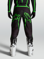 Alpinestars Fluid Apex V2 Broek, motocrossbroek voor heren, zwart en neon groen, achteraanzicht op model met stergrafieken.