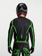 Alpinestars Fluid Apex V2 jersey, motocross, zwart en fluoriserend groen, achteraanzicht met verlengde achterzoom.