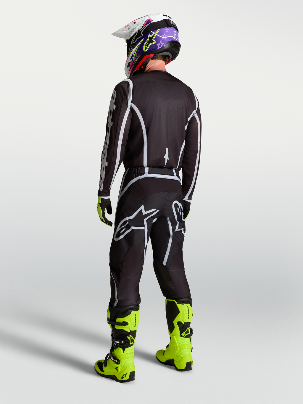 Alpinestars Fluid Apex V2 jersey, heren motorcrossjersey in zwart en zilver, sportieve pasvorm van achteren gezien.
