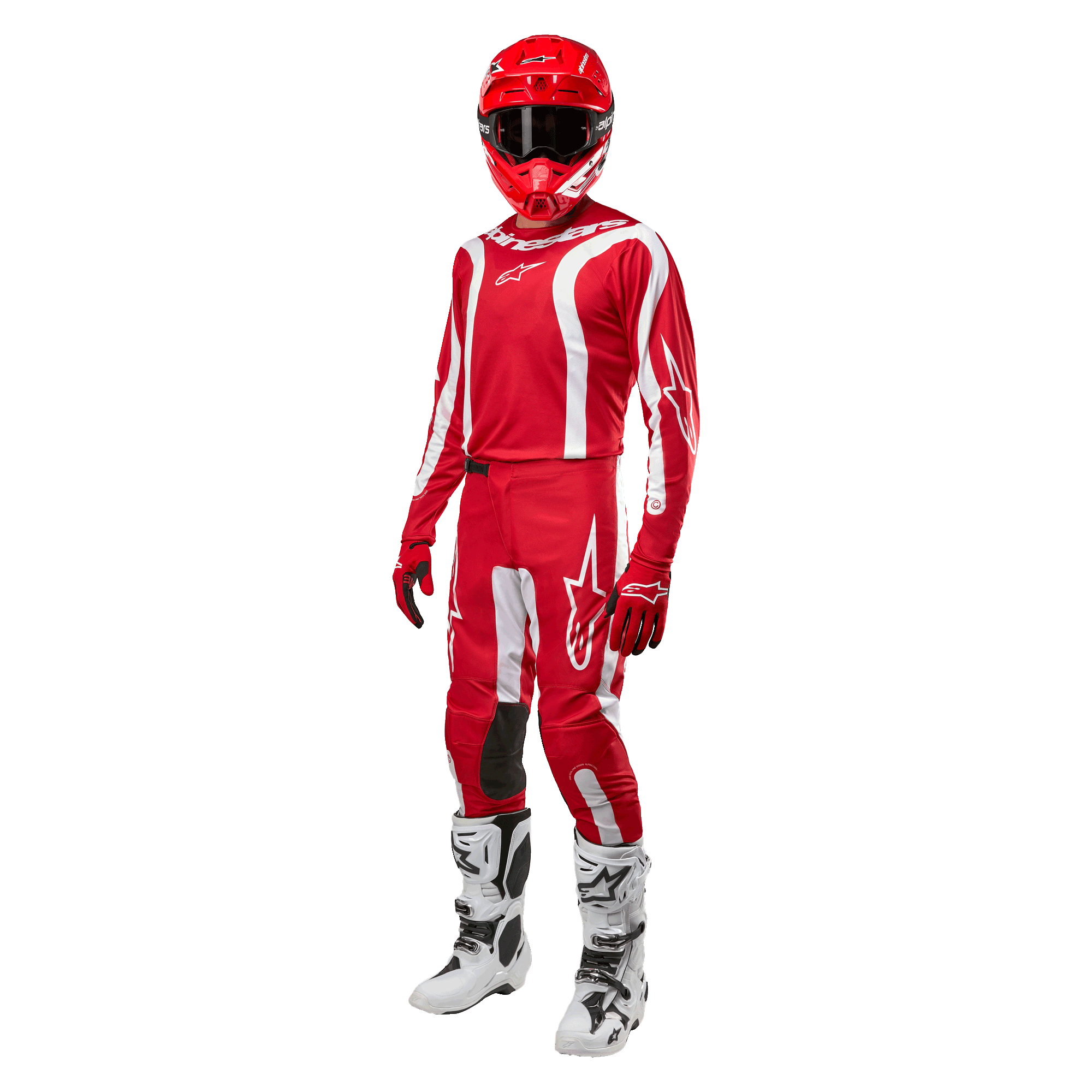 Motorcrosser in volledige race-uitrusting, Alpinestars 2024 Fluid Lurv Jersey in Mars Red en wit, bijpassende rode broek met witte accenten, rode helm, rode handschoenen en witte en zwarte laarzen, gecoördineerde outfit voor off-road racen