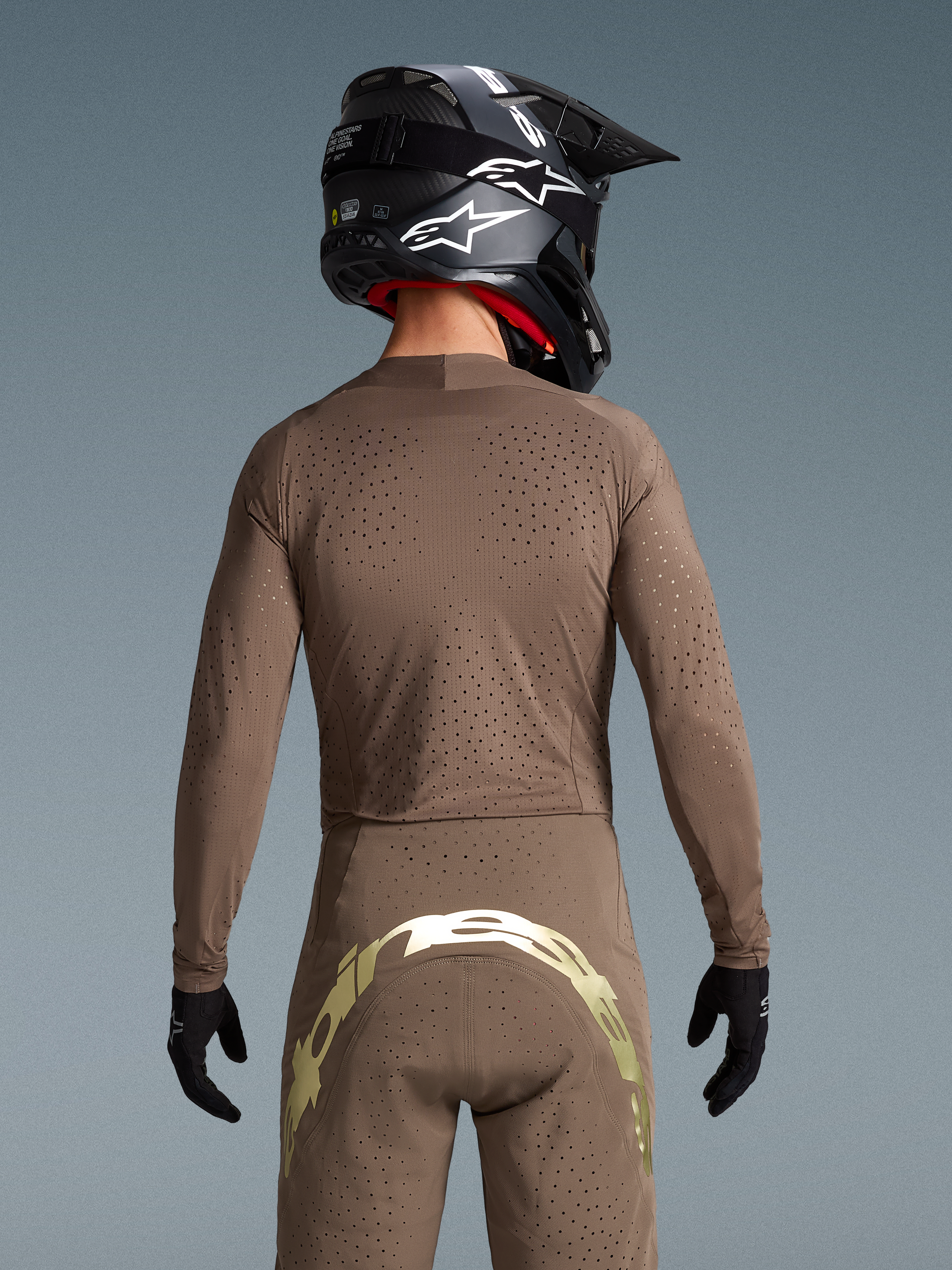 Alpinestars Limited Edition Supertech Air Gold Gear Set, rear view showing laser-cut ventilation and metallic branding.