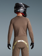 Alpinestars Limited Edition Supertech Air Gold Jersey and MX pants in Earth Brown and Gold with laser-cut ventilation.