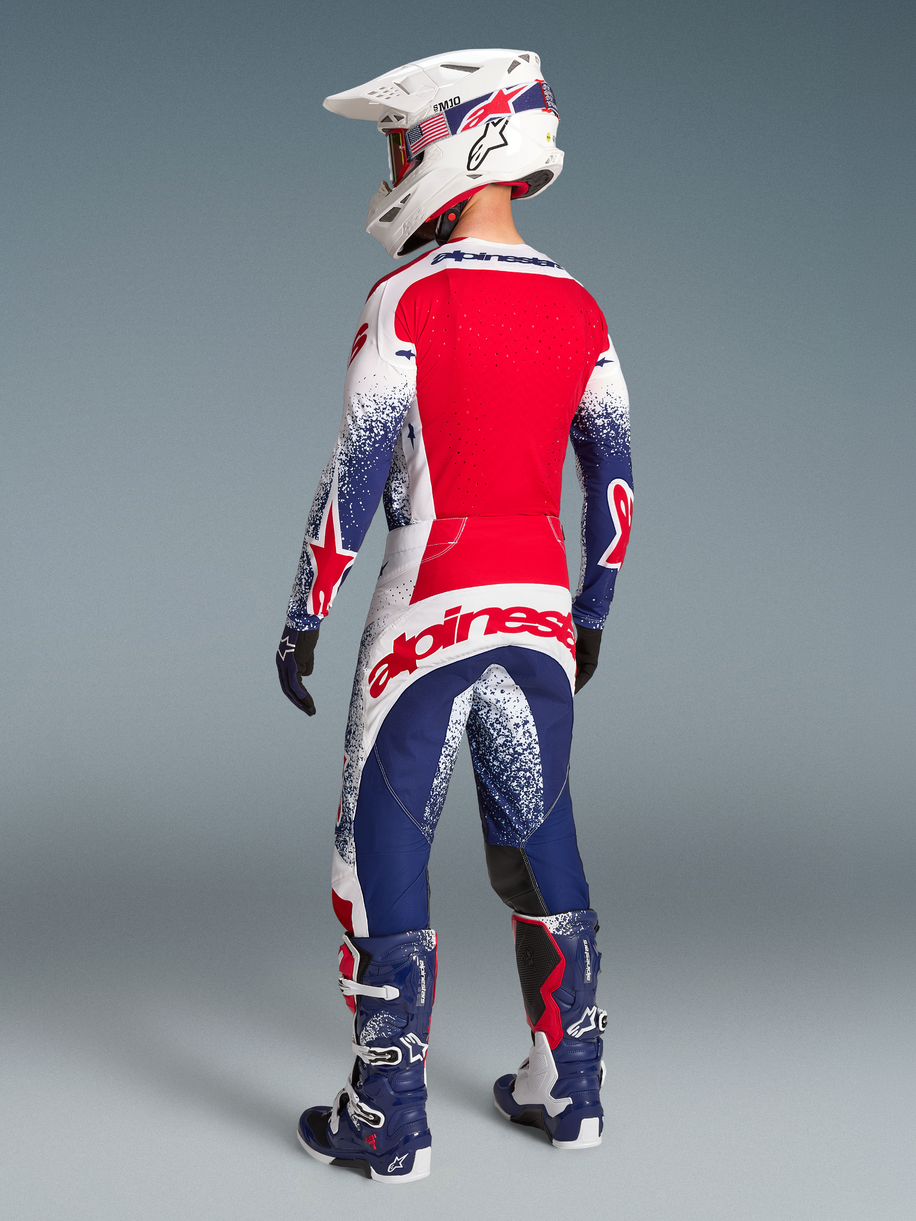 Alpinestars Techstar Unity limited edition broek en jersey, motorcrosskleding heren, rood, wit en blauw, achteraanzicht.
