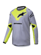 Alpinestars 2025 Youth Racer Veil Jersey, jeugd motorcrossshirt met lange mouwen, grijs en fluoriserend geel, zwarte logo's, lichtgewicht ademende stof, zwarte hals en boorden, geometrisch ontwerp