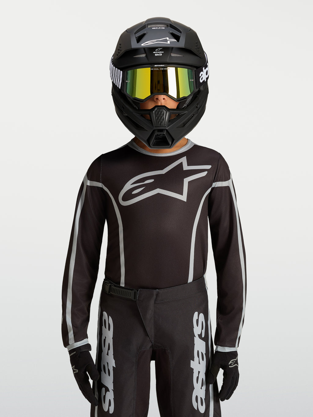 Alpinestars Jeugd Fluid Apex V2 Jersey, zwart en zilver, motocross jersey met ergonomische atletische pasvorm.