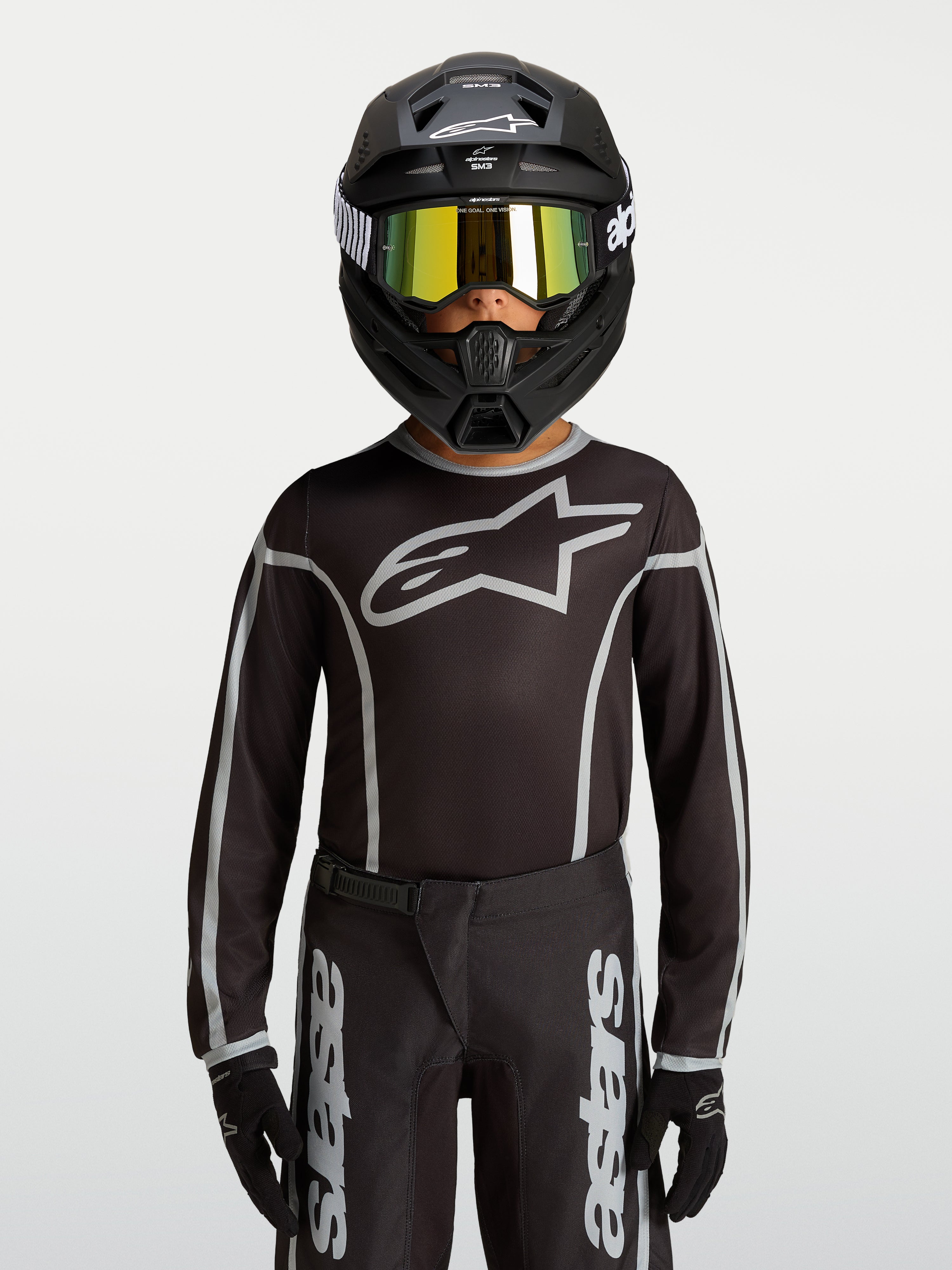 Alpinestars Jeugd Fluid Apex V2 Jersey, zwart en zilver, motocross jersey met ergonomische atletische pasvorm.