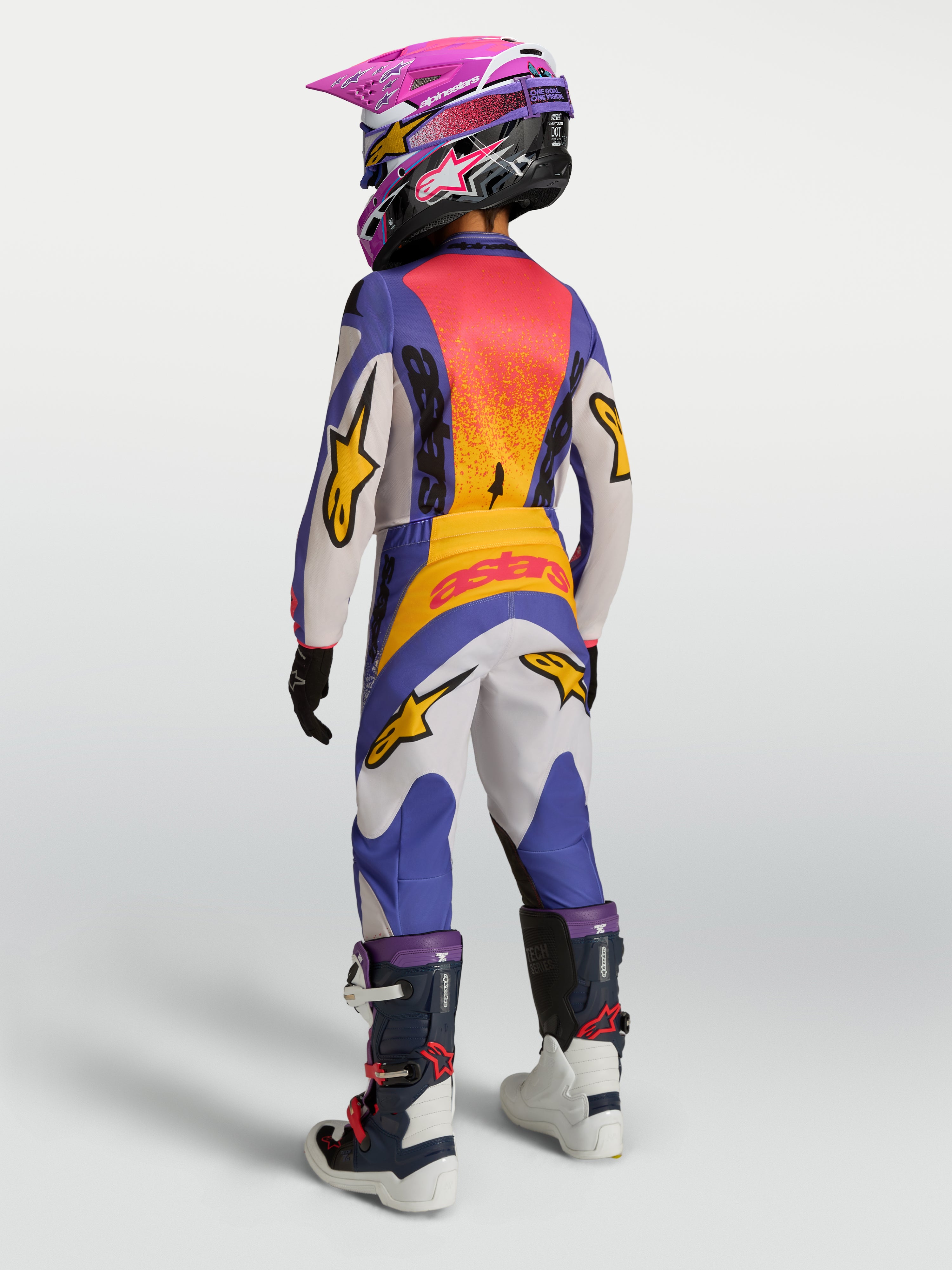 Alpinestars Jeugd Fluid Drag jersey 2027 en gear set, blauwe en gouden motorcross-outfit met verlengd rugpand.